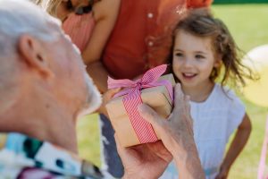 grandparents giving gifts to grandchildren