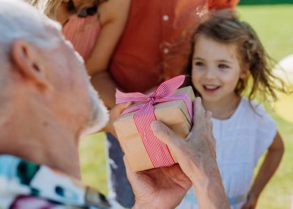 grandparents giving gifts to grandchildren